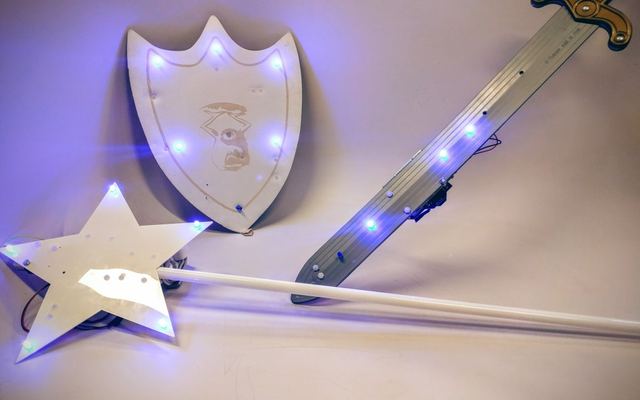 The game's three LED-lit weapons: a shield, a sword and a star wand