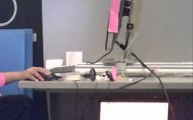Video still: the moving-screen setup at a desk