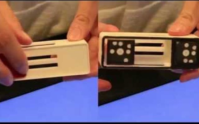Video still: hands holding two white tangible circuit blocks